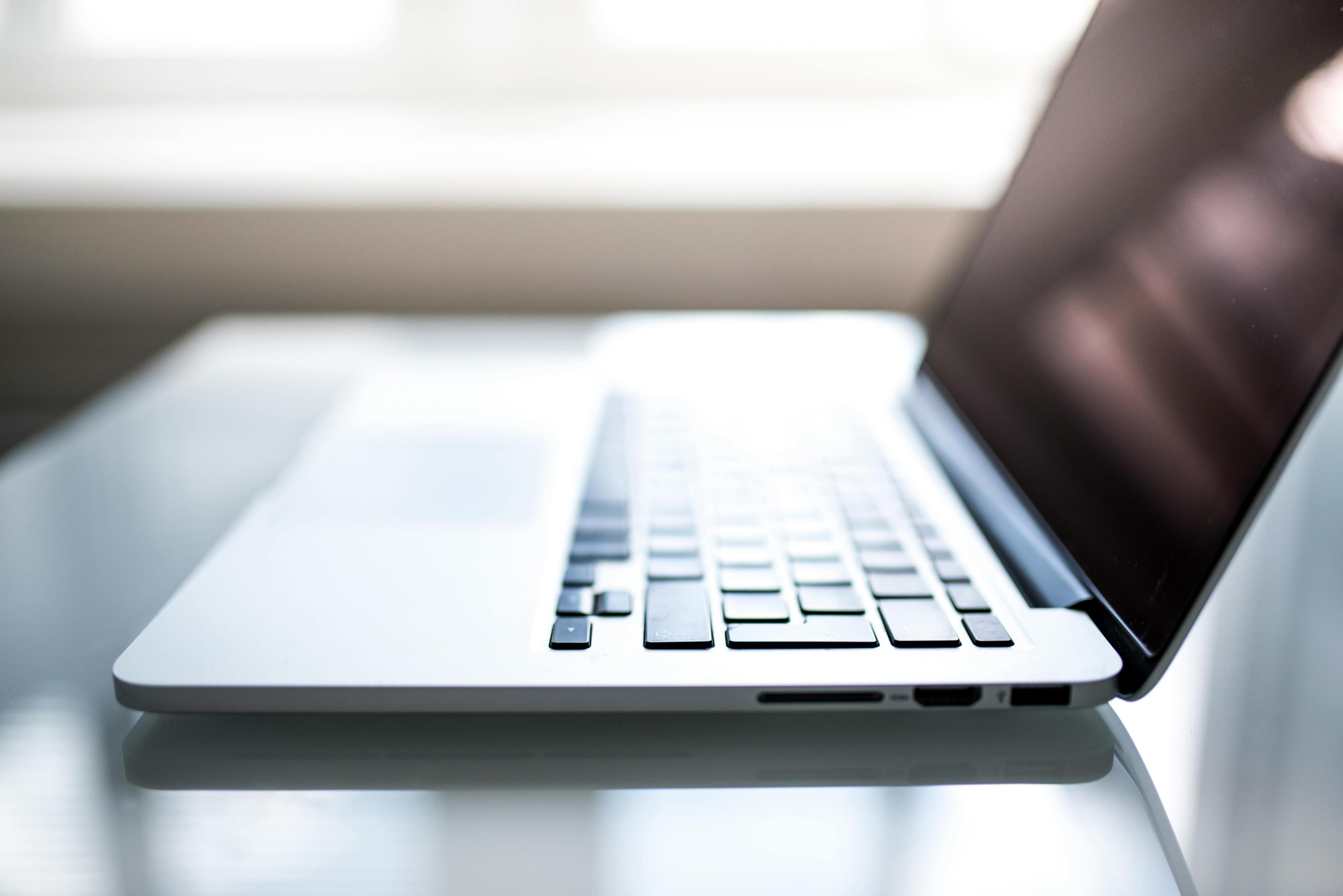 A laptop open on a study desk