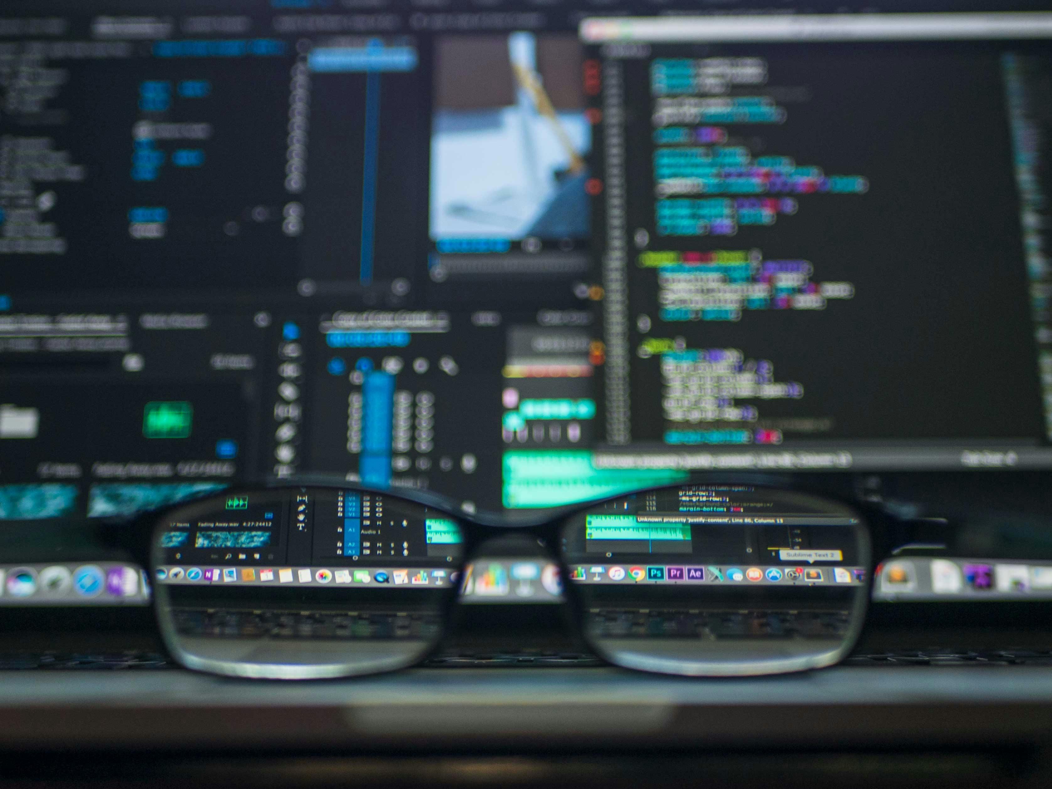 Reading glasses in front of code on a screen
